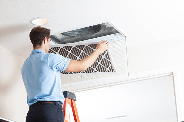 man cleaning air ducts in home. man cleaning air ducts in home.